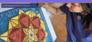 Kristen Palana painting a geometric mandala in bright blue, yellow, and red—closeup of art and artist’s hand.